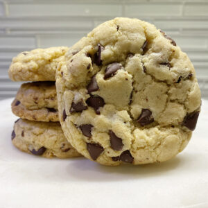 A stack of cookies with chocolate chips on top.
