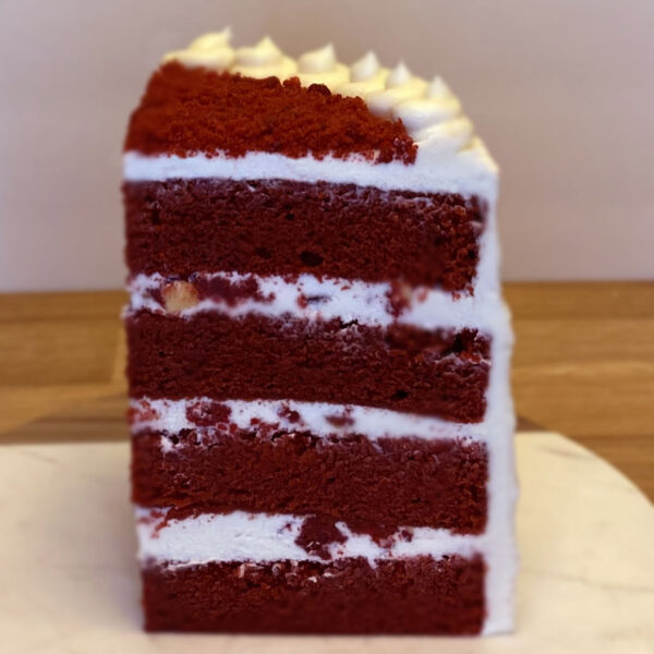 A red velvet cake with white frosting on top.