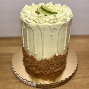 A cake with white frosting and lime on top.