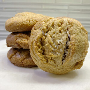 A stack of cookies on top of a white plate.